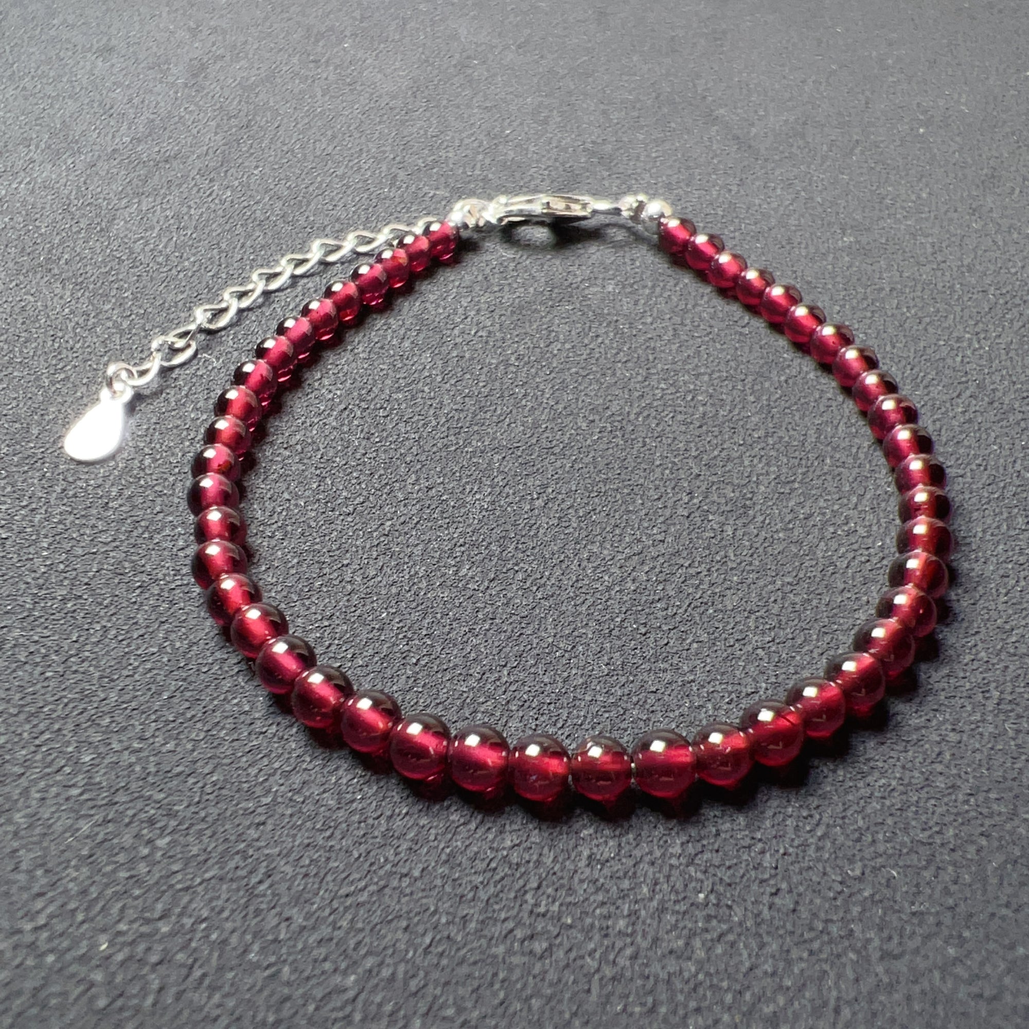 Crafted with care, this bracelet features natural, high-quality 3.5mm garnet beads, totaling 46 beads in all.