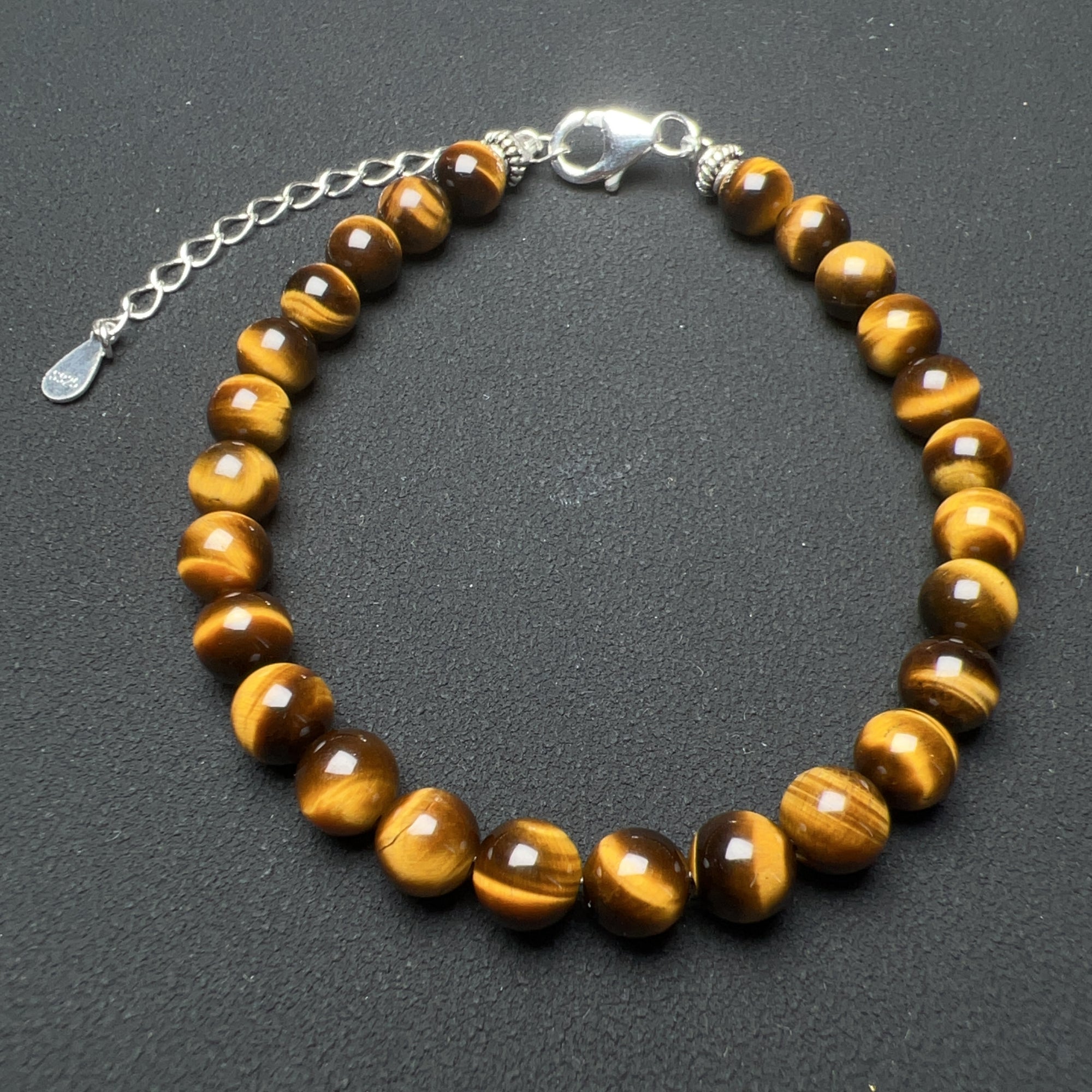 Enhance your style and promote positive energy with our 6mm Top-grade Brown Tiger Eye Healing Crystal Gemstones Bracelet. 