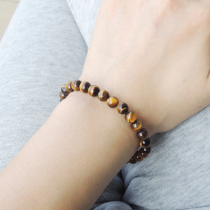 Crafted with natural, high-quality healing gemstones, this bracelet features 6mm top-grade Brown Tiger Eye beads, totaling 26 beads in all.